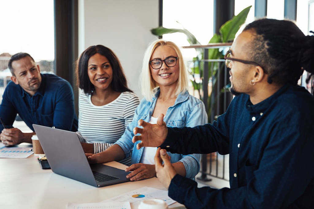 Four people strategic planning in an office for their HOA