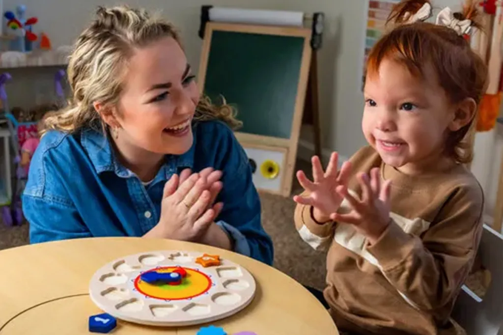 Woman playing with young child at Developmental Pathways