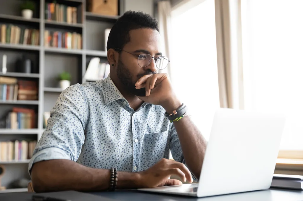 Concerned man using laptop